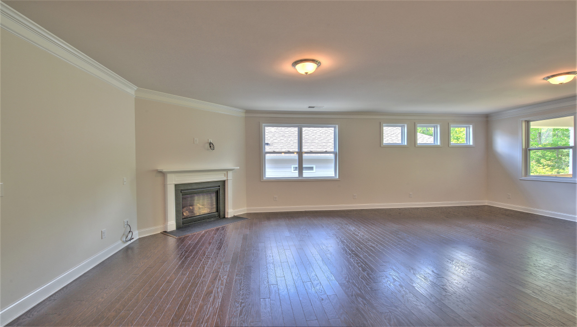 Open living area with large windows and fireplace