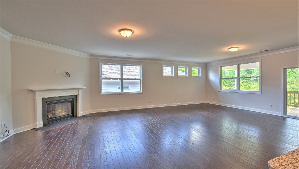 Open living area with large windows and fireplace