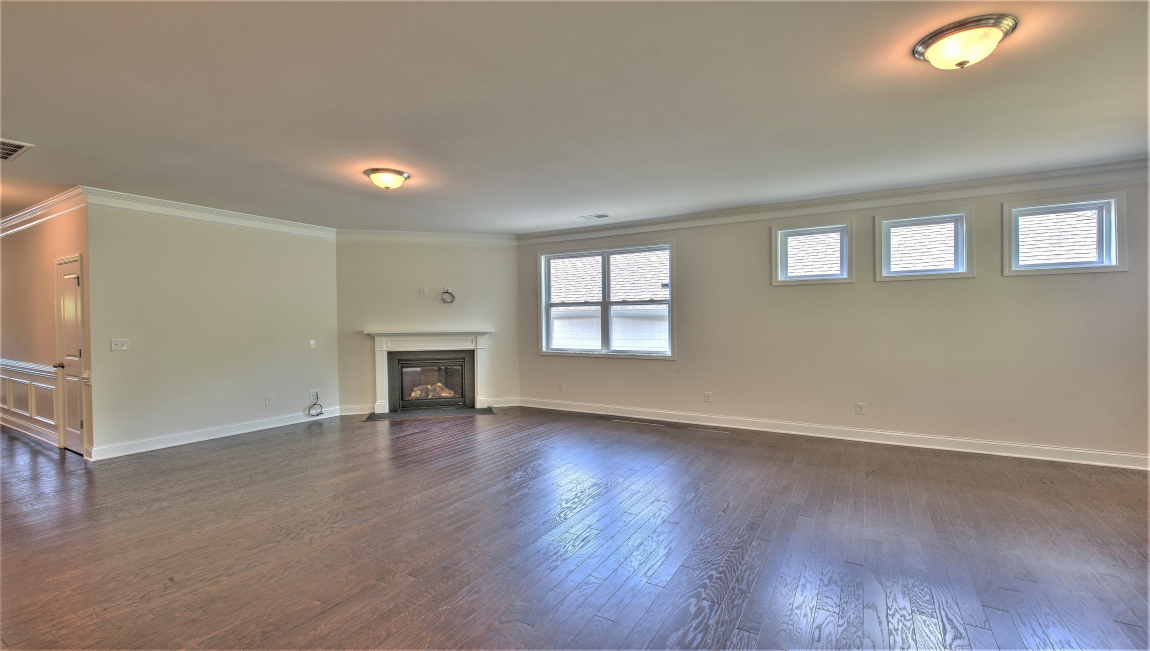 Open living area with large windows and fireplace