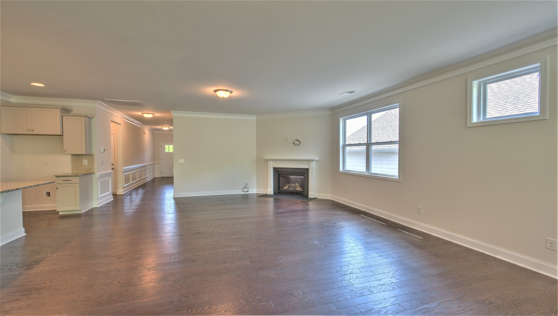 Open living area with large windows and fireplace
