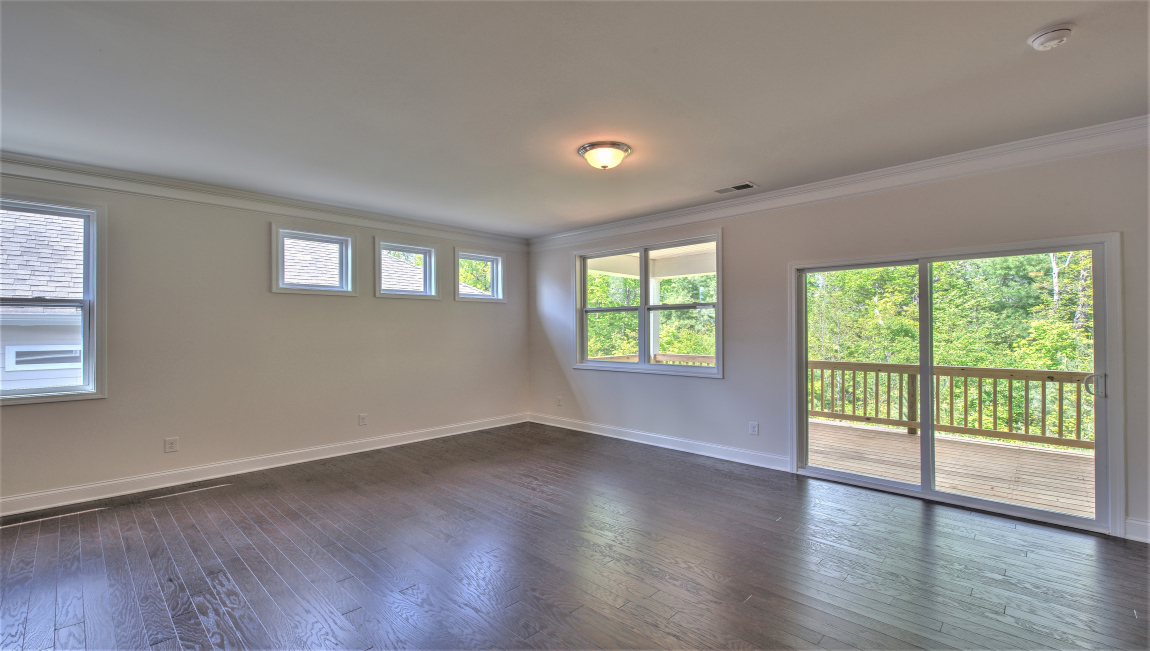 Open living area with large windows and fireplace