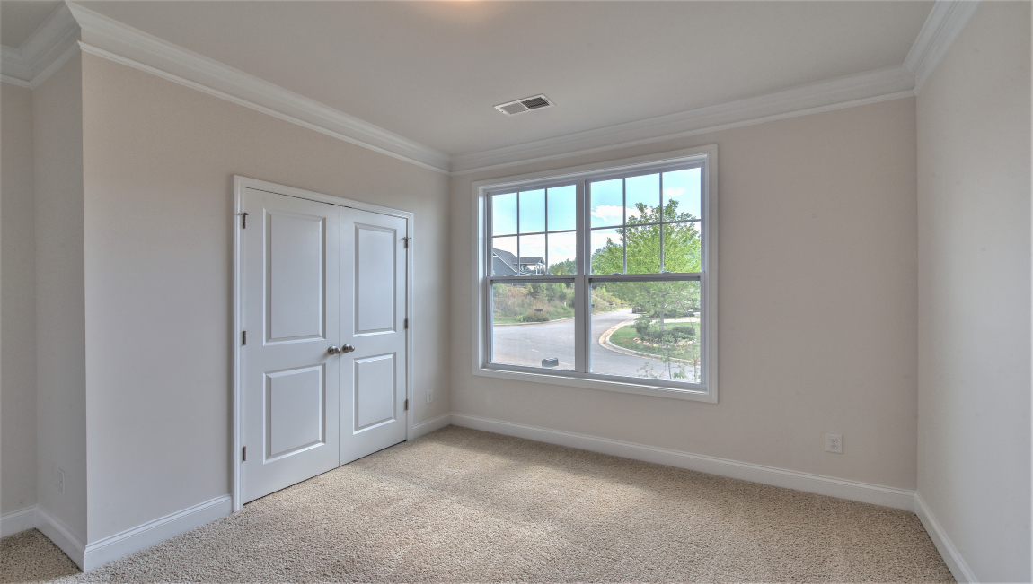 Carpeted bedroom with large window