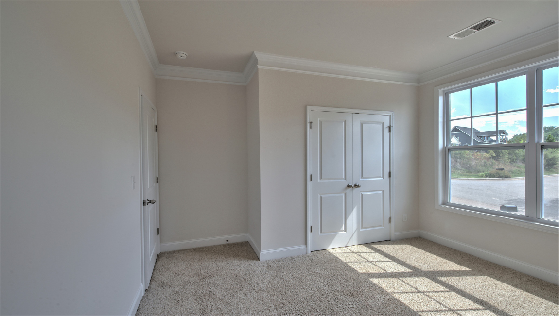 Carpeted bedroom with large window