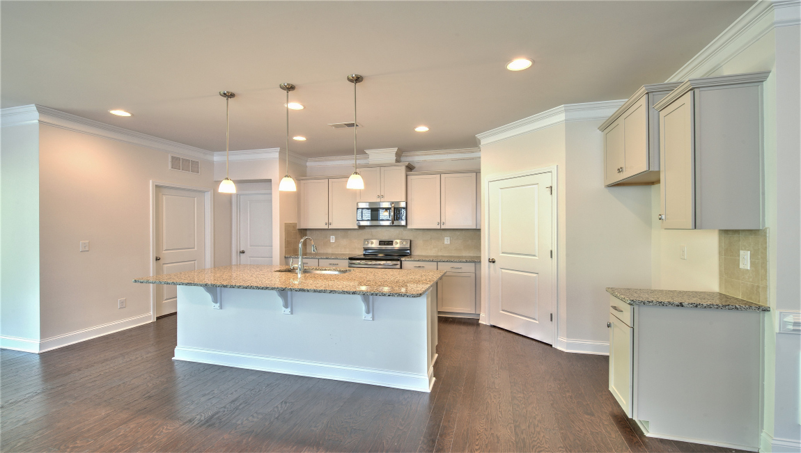 Open concept kitchen with island and stainless steel appliances