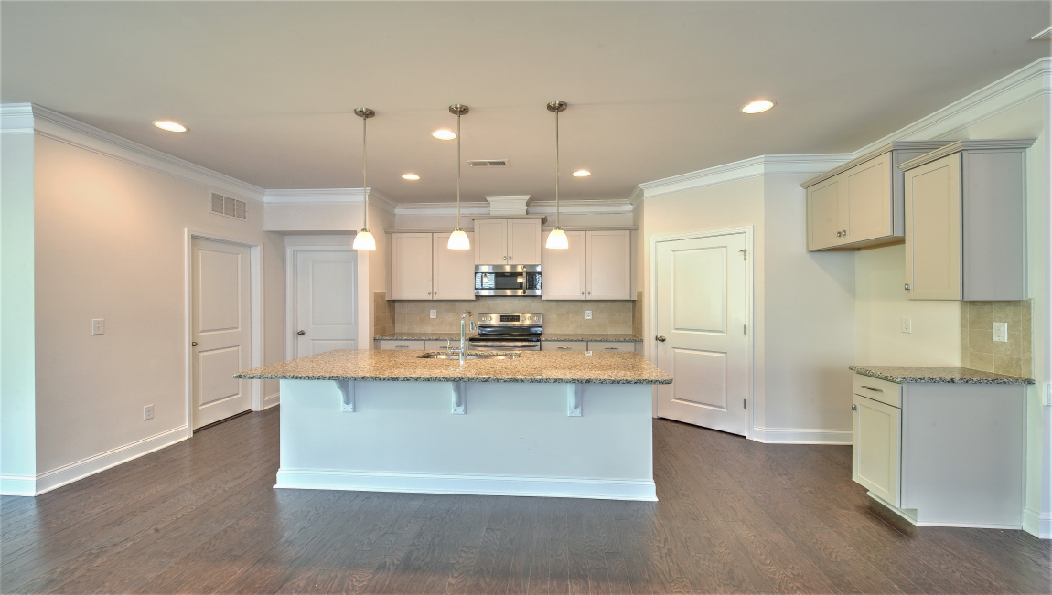 Open concept kitchen with island and stainless steel appliances