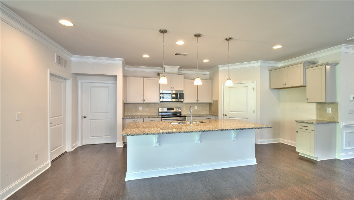 Open concept kitchen with island and stainless steel appliances