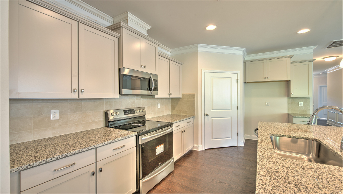 Open concept kitchen with island and stainless steel appliances