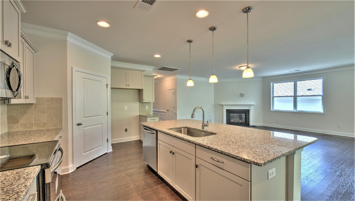 Open concept kitchen with island and stainless steel appliances