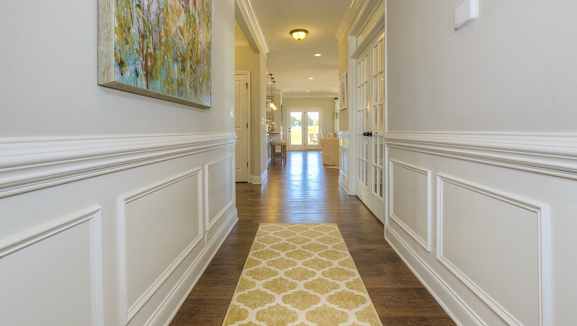 Welcoming foyer with wood floors, view of french doors, front door and staircase