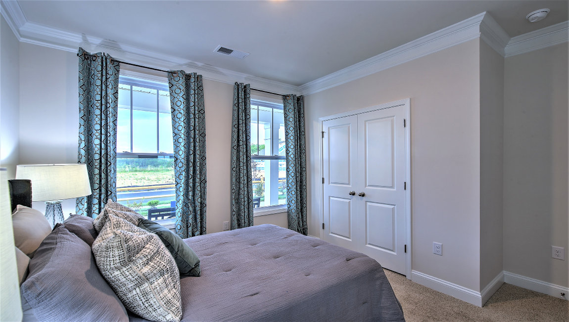 Carpeted bedroom with large windows