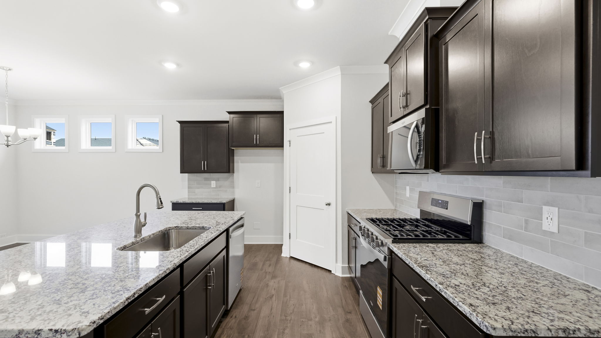 Open concept kitchen with large island and stainless steel appliances