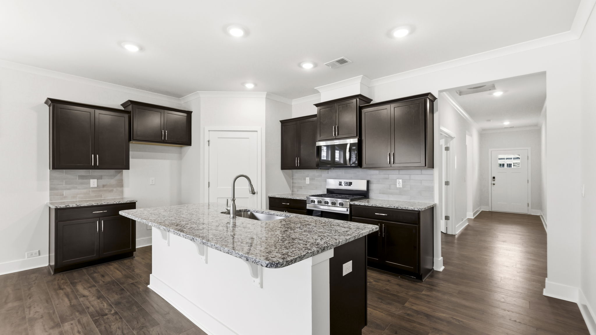 Open concept kitchen with large island and stainless steel appliances