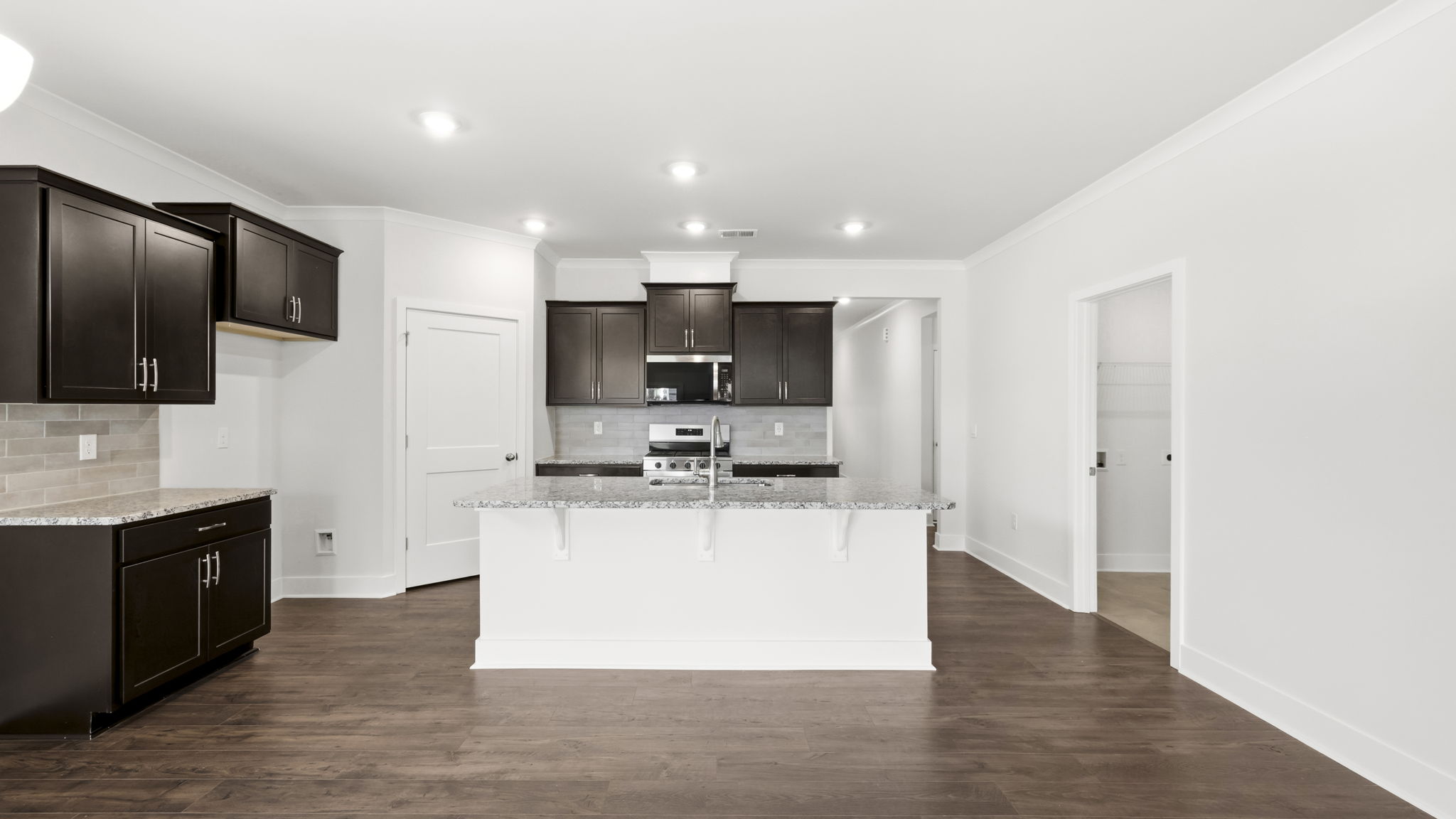 Open concept kitchen with large island and stainless steel appliances