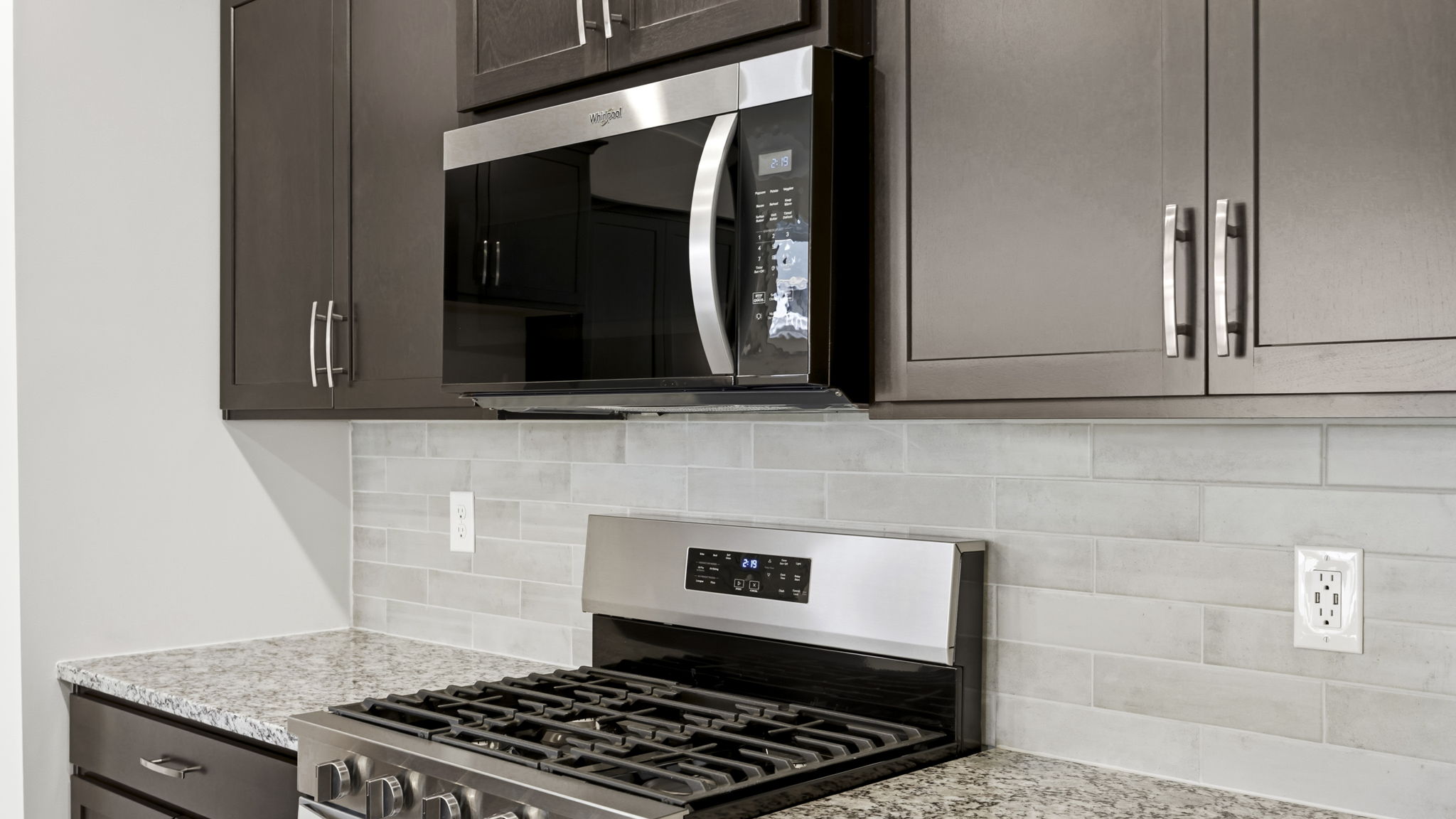 Open concept kitchen with large island and stainless steel appliances
