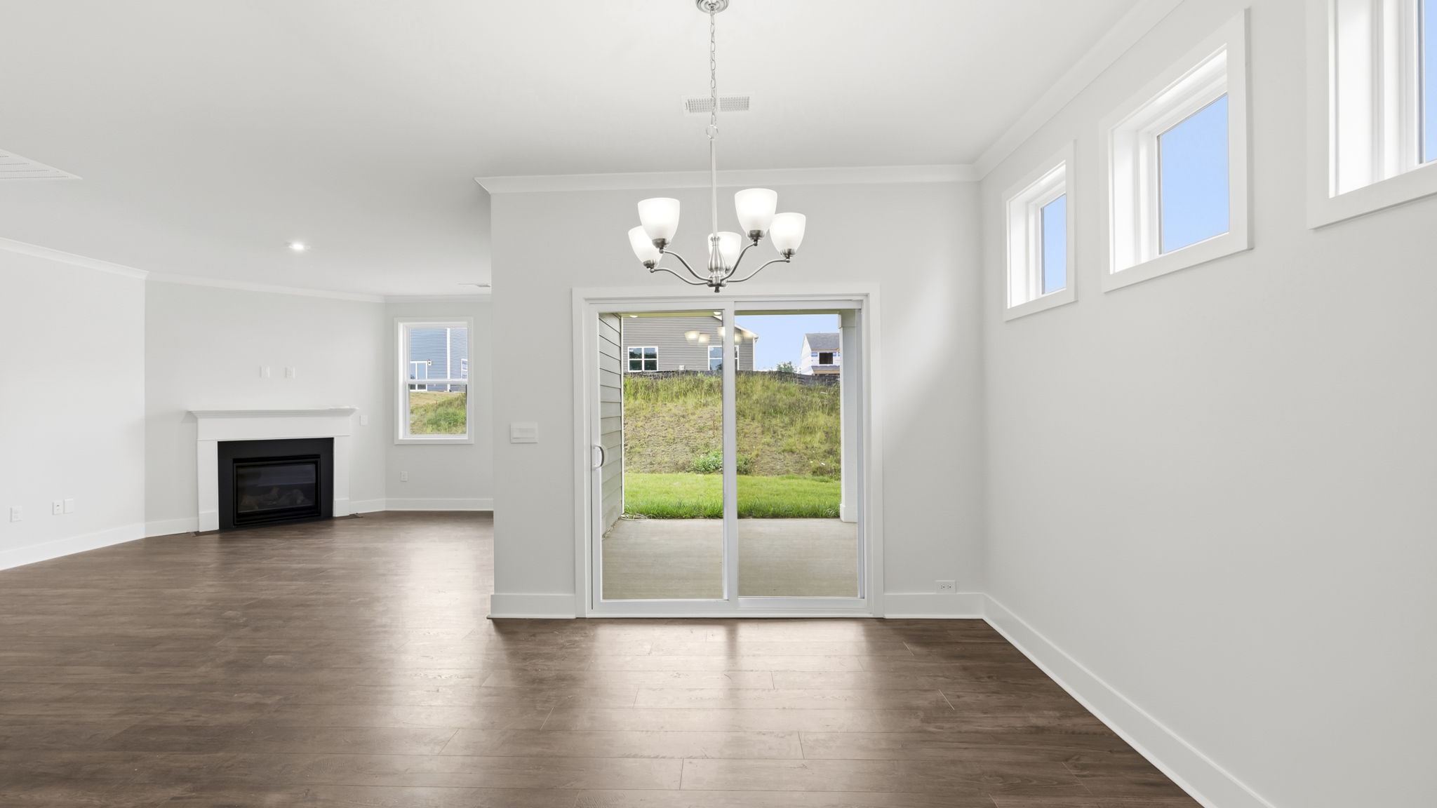 Open concept living area with gas fireplace and sliding glass doors