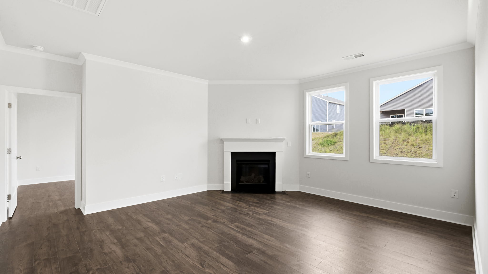 Open concept living area with large windows and gas fireplace