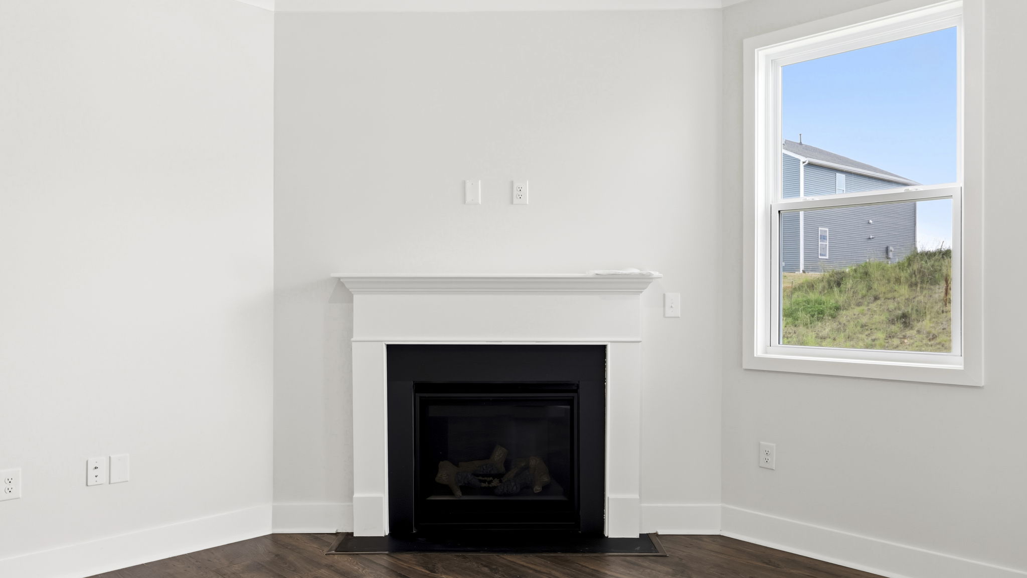 Open concept living area with large windows and gas fireplace
