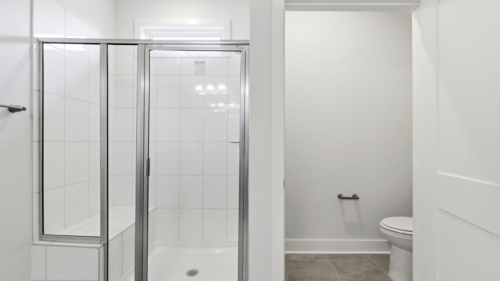 Primary bathroom with glass doors to walk in shower