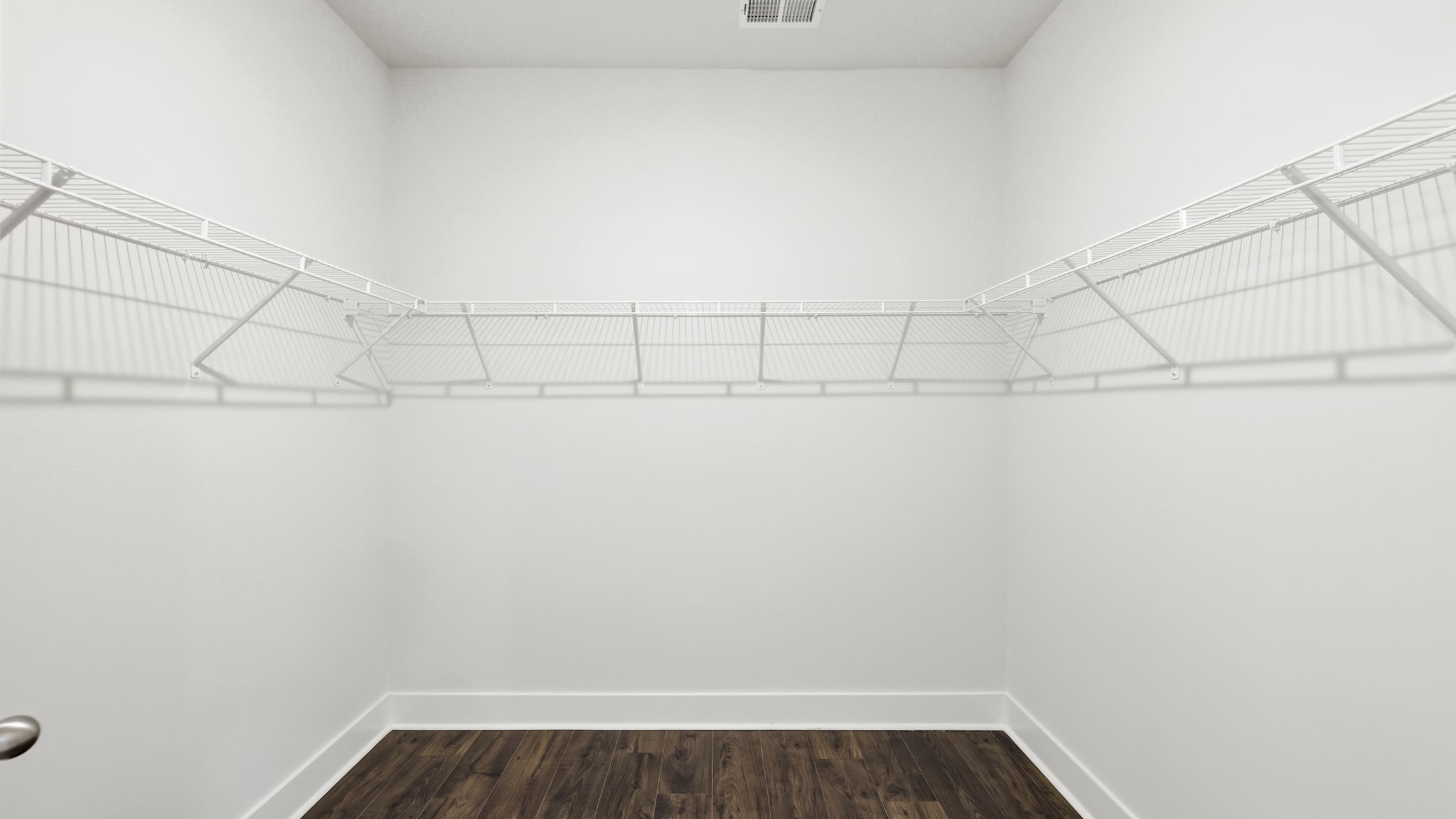 Primary walk in closet with shelving