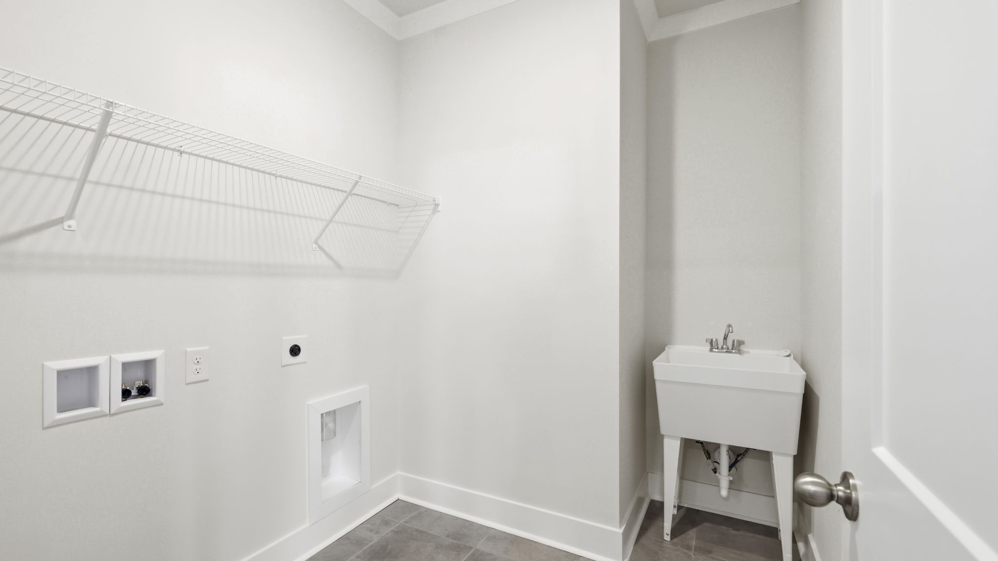 Laundry room with shelving and utility sink