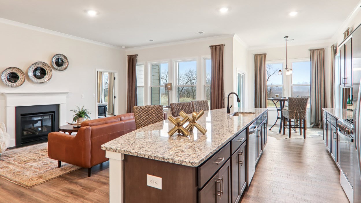 Open kitchen with ten foot island and stainless steel appliances