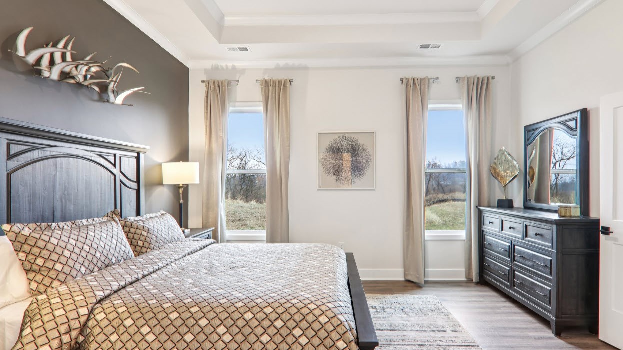 Primary bedroom with large windows