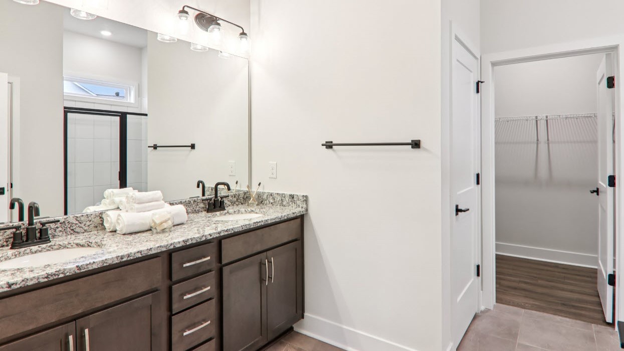 Primary bathroom with double vanity and walk in shower