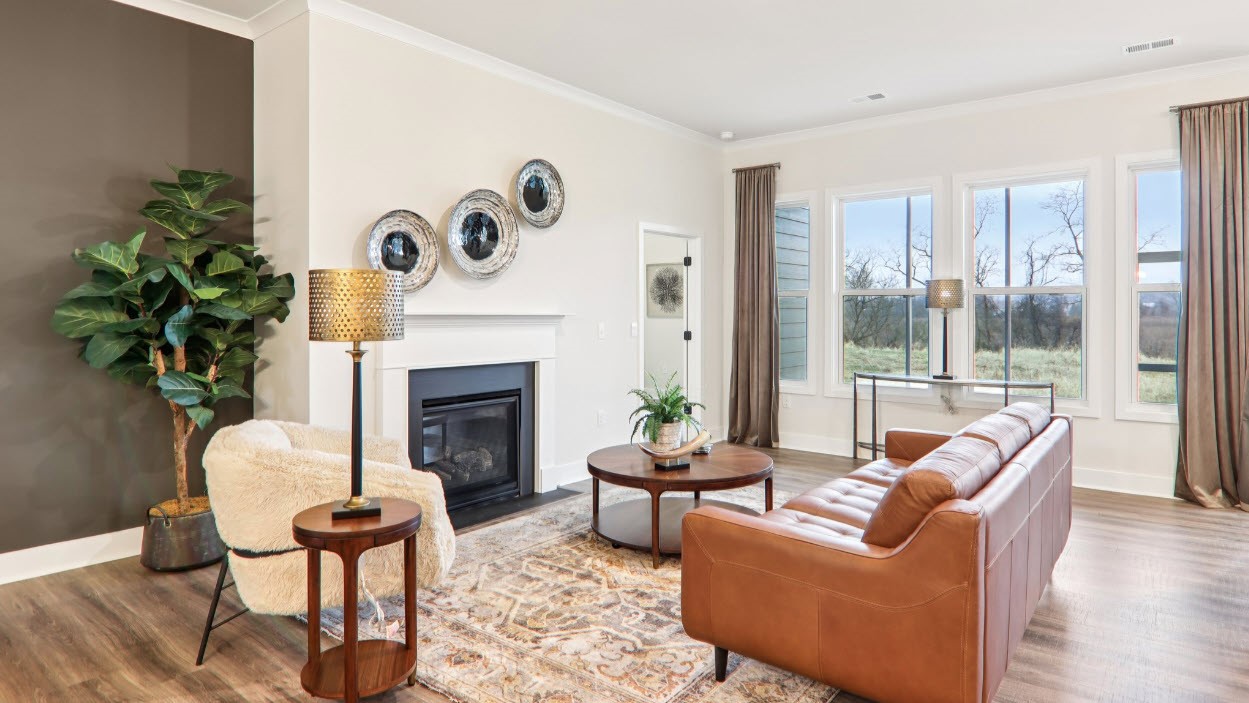 Great room with large windows and fireplace