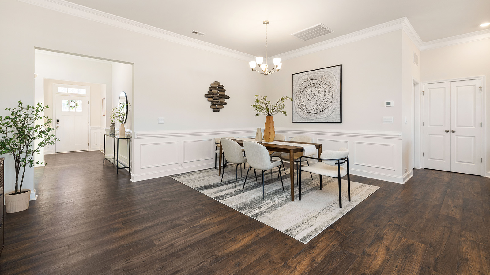 Dining area with wood floors and view of foyer