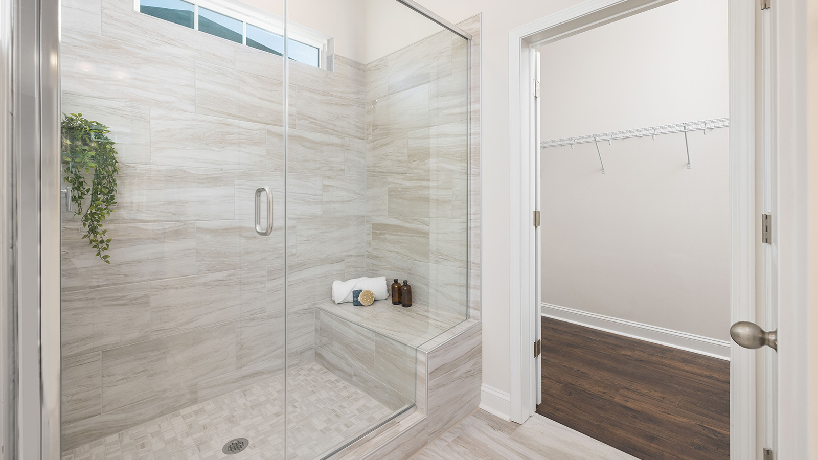Primary bathroom with double sinks, white cabinets