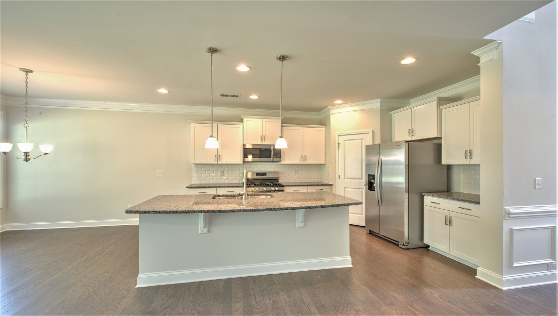 Open concept kitchen with large island and stainless steel appliances