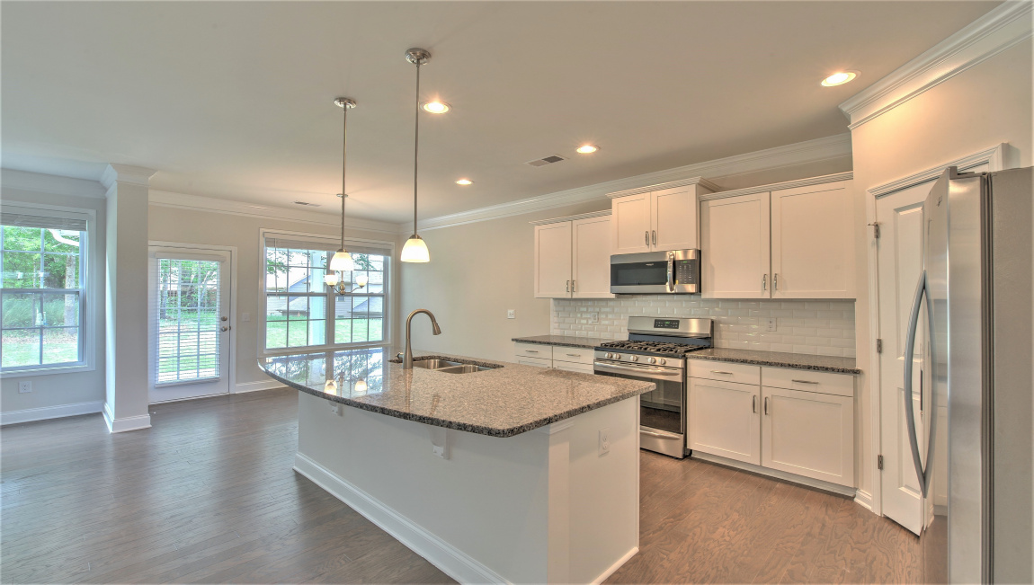 Open concept kitchen with large island and stainless steel appliances