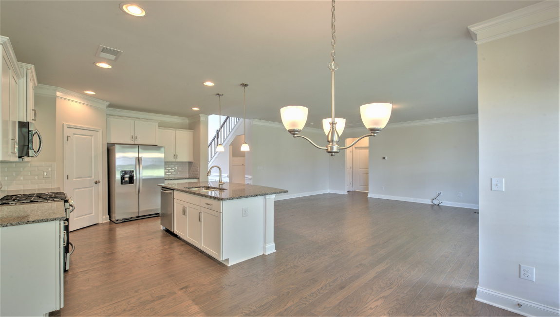 Open concept kitchen with large island and stainless steel appliances