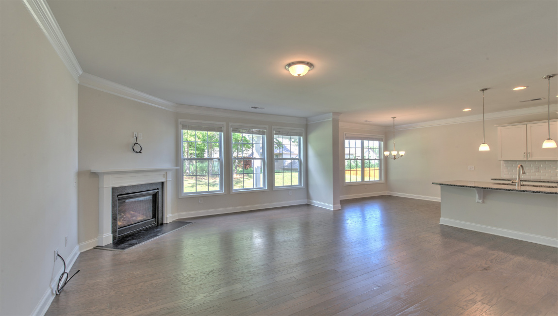 Large and open family room with large windows and gas fireplace