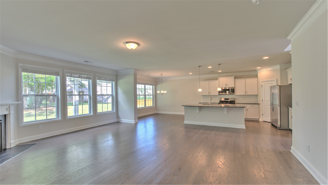 Large and open family room with large windows and gas fireplace