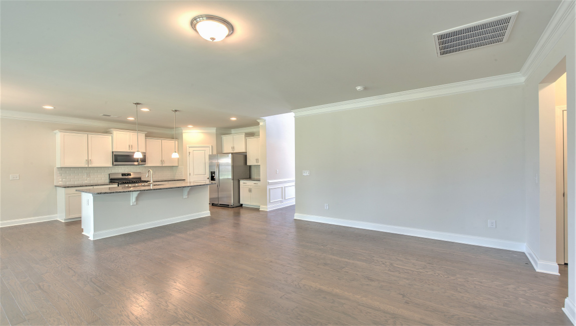 Large and open family room with large windows and gas fireplace