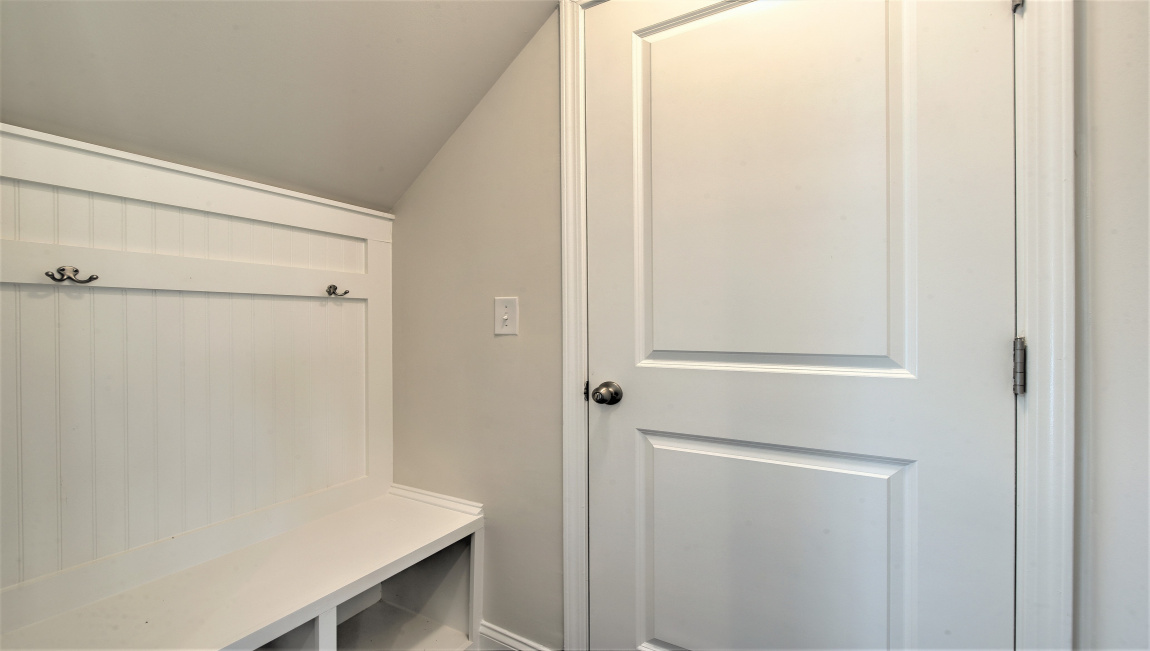 Drop zone with shelving next to garage door