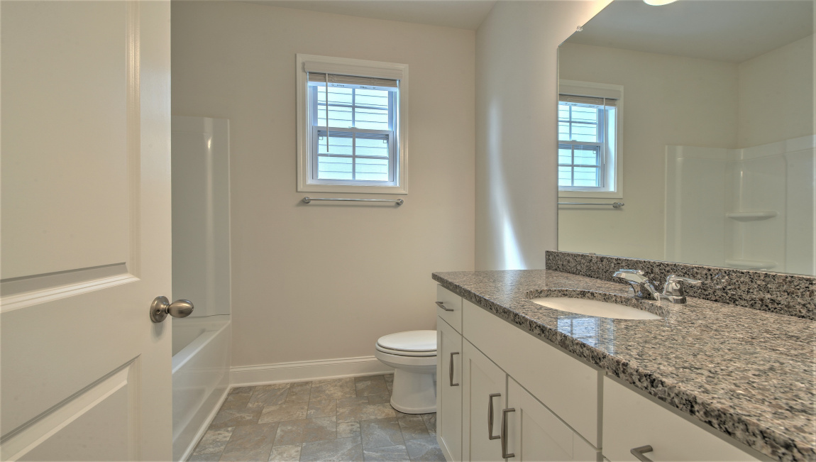 Bathroom with dual vanity and bathtub