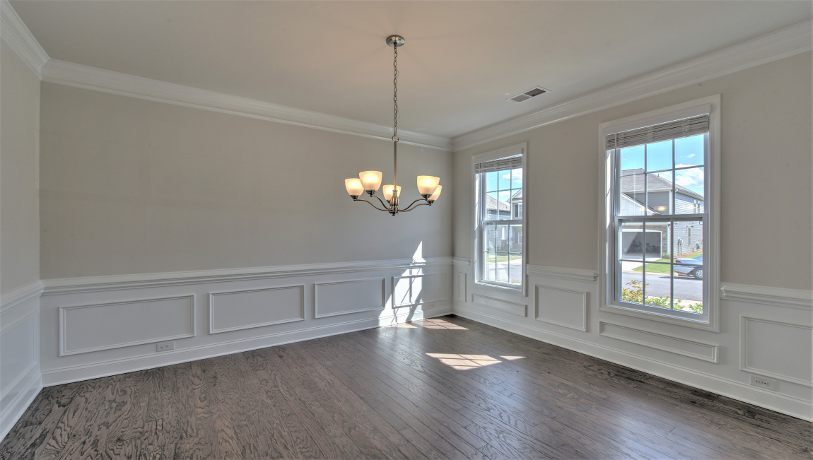 Formal dining room with windows and hanging light fixture