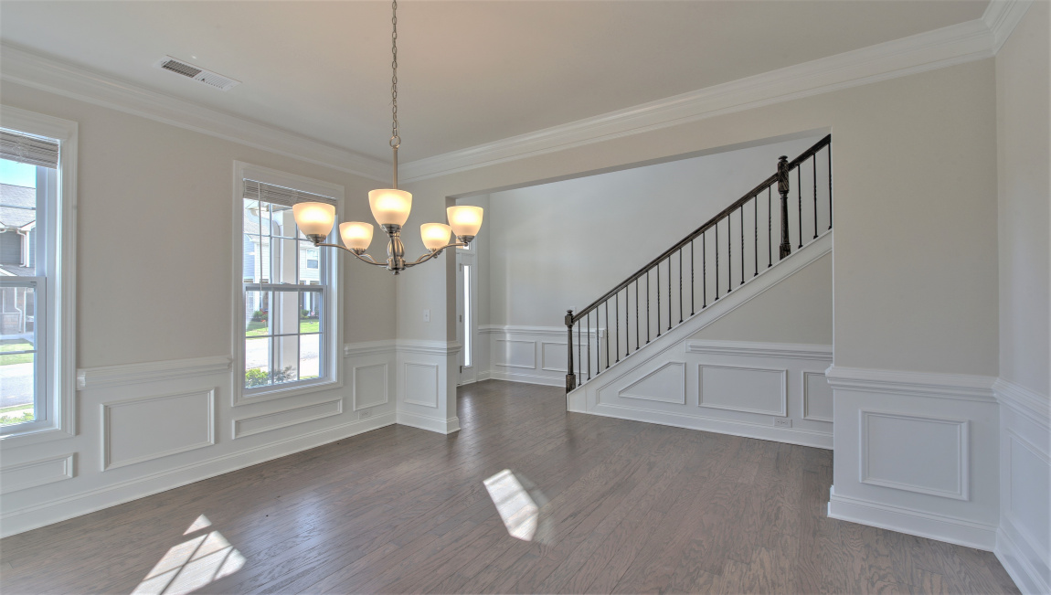 Formal dining room with windows and hanging light fixture