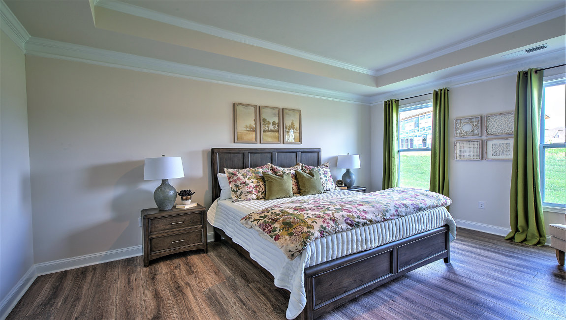 Primary bedroom with large windows