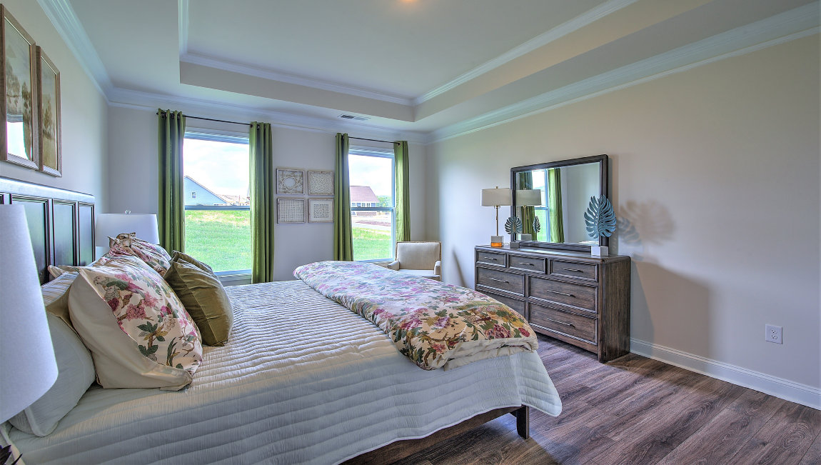 Primary bedroom with large windows