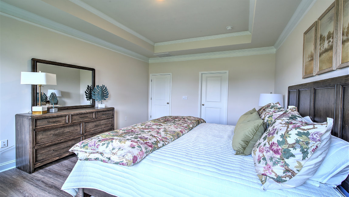 Primary bedroom with large windows
