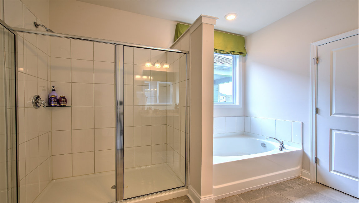 Primary bathroom with tub and walk in shower