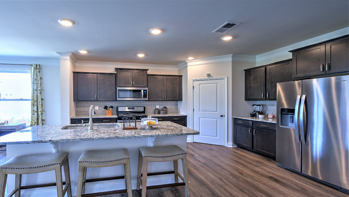 Open kitchen with island and stainless steel appliances