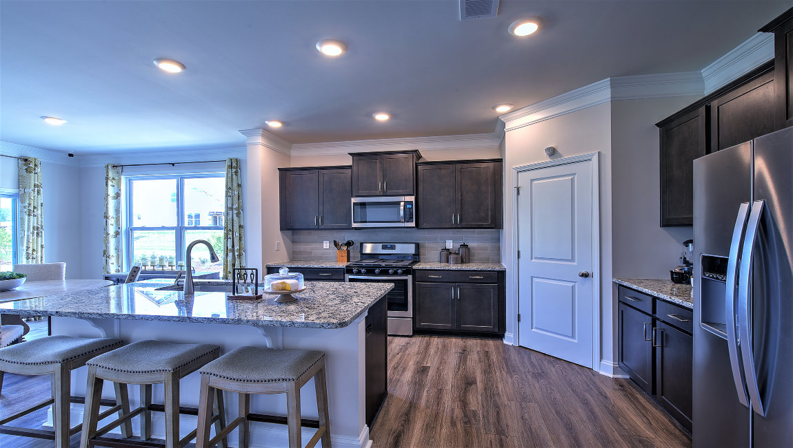 Open kitchen with island and stainless steel appliances