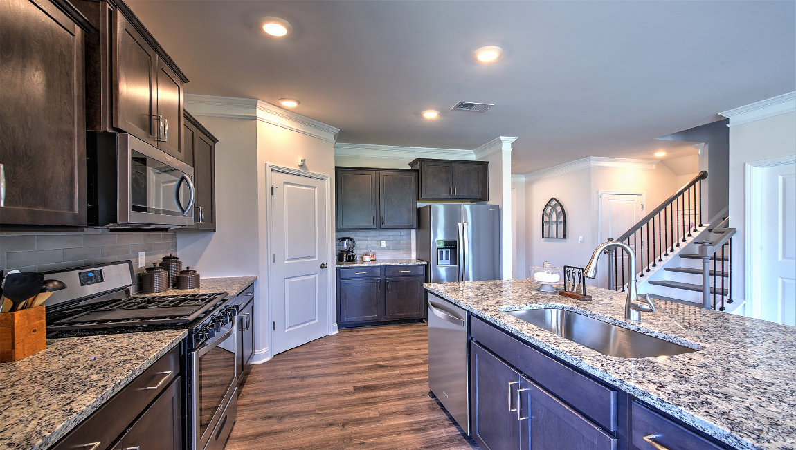 Open kitchen with island and stainless steel appliances