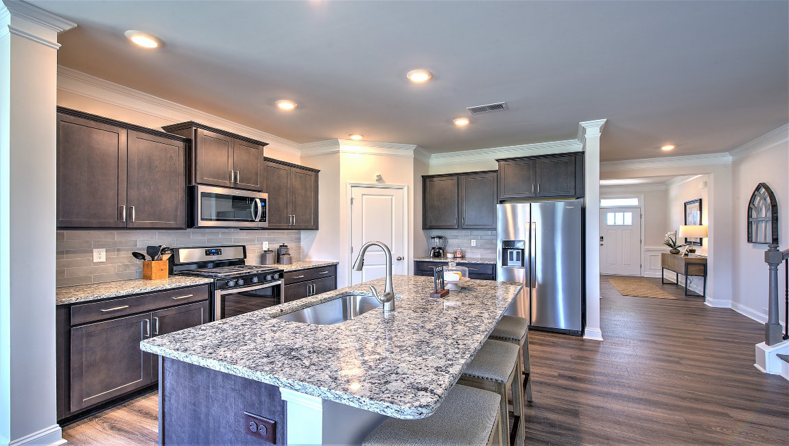 Open kitchen with island and stainless steel appliances