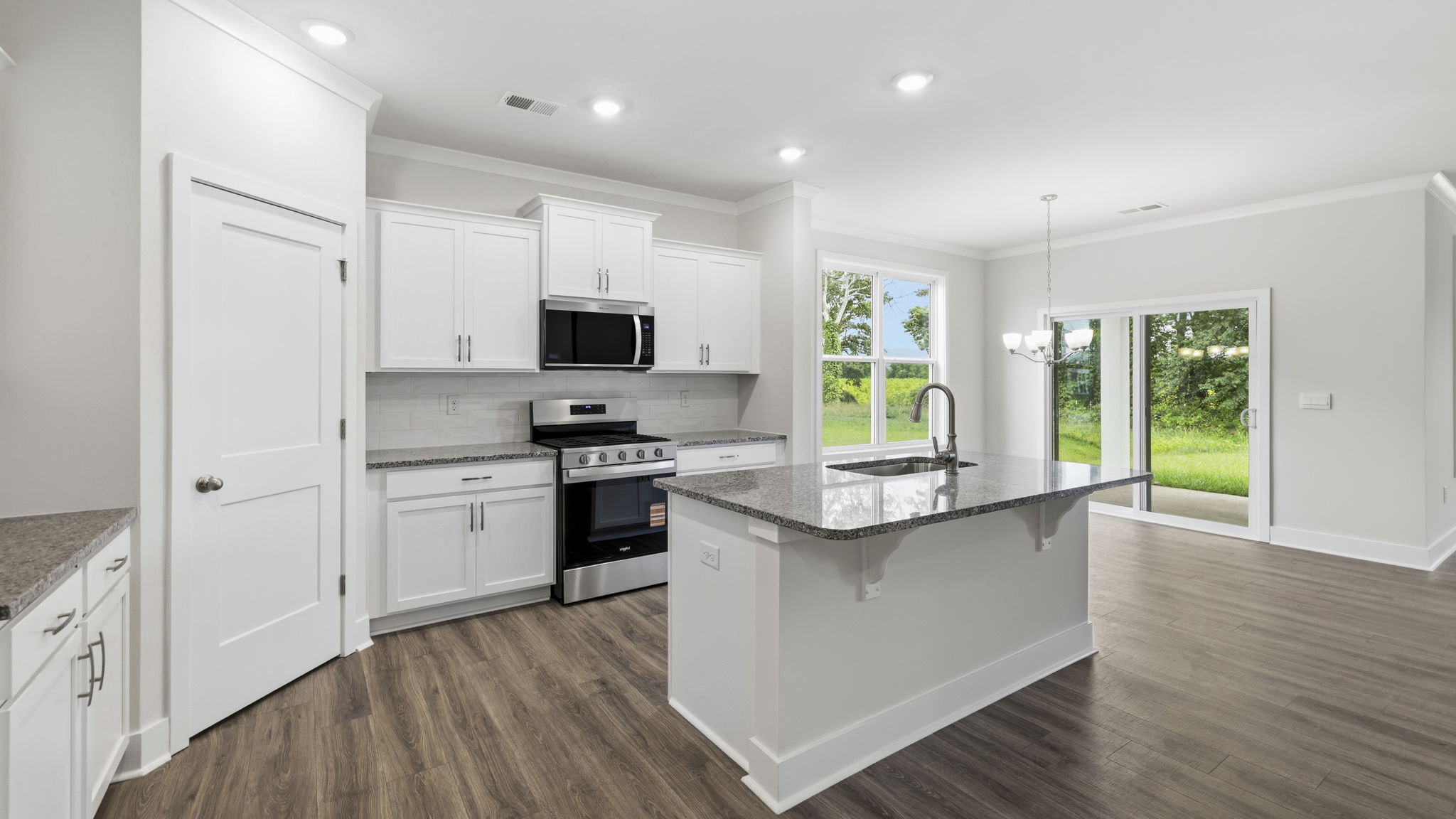 Open concept kitchen with large island and stainless steel appliances