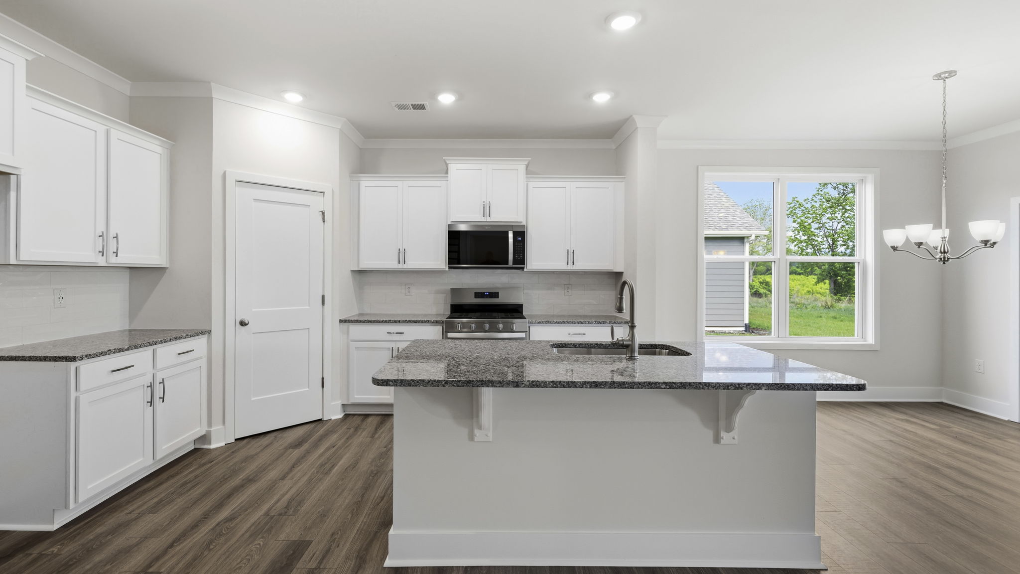 Open concept kitchen with large island and stainless steel appliances